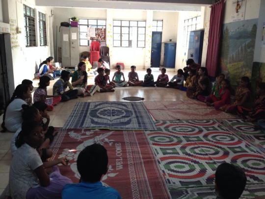 Young women gathered in a circle for the Hearts of the World workshop at Kasba Girls Home in Kolkata