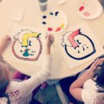 NYU students painting hearts at Hearts of the World collaboration workshop in New York City